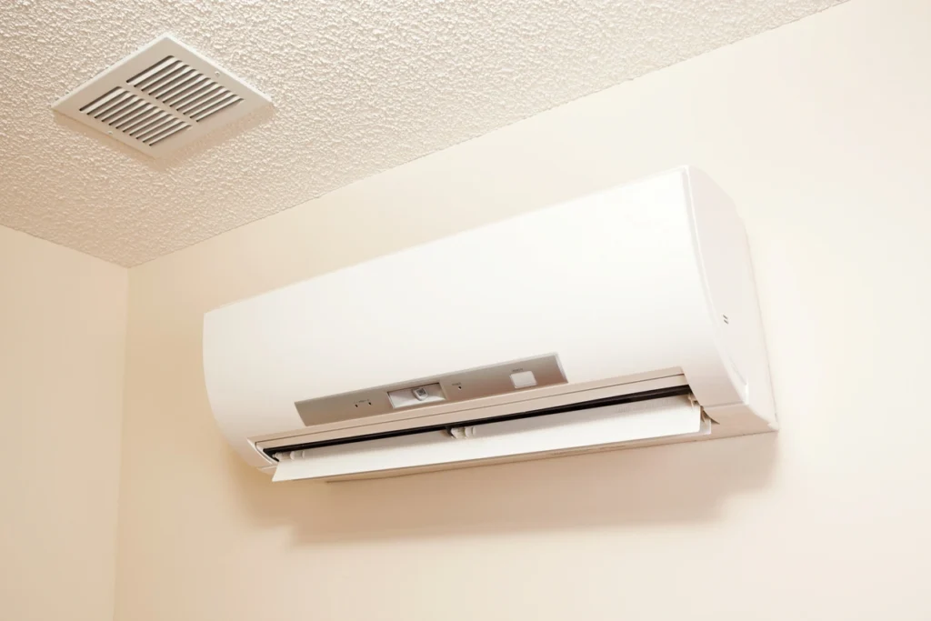 A white air conditioner installed on a wall, providing efficient cooling for the room.